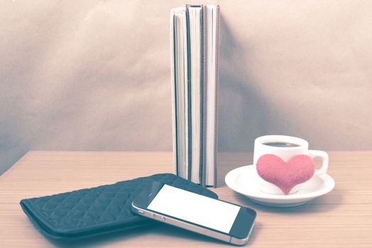 working table : coffee with phone,stack of book,wallet and heart on wood background vintage style