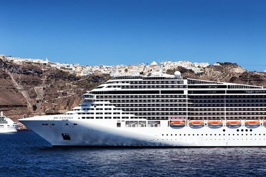 MSC Fantasia cruise ship near Santorini island in Aegean sea