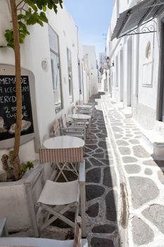 Narrow street with traditional white houses in Parikia, Paros, Greece