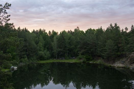 Lake in the stone canyon surrounded by forest