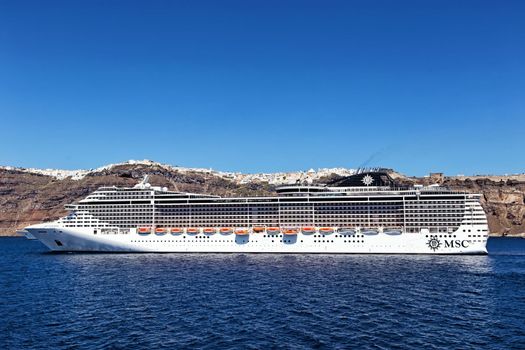 MSC Fantasia cruise ship near Santorini island in Aegean sea