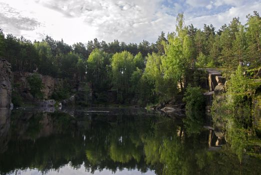 Lake in the stone canyon surrounded by forest