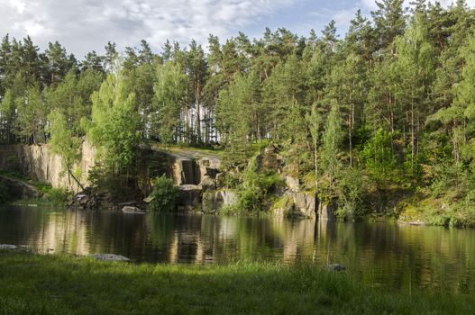 Lake in the stone canyon surrounded by forest