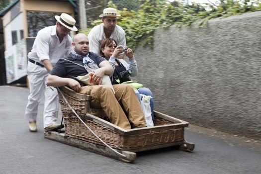 raditional downhill sledge trip on May 20, 2015 in Madeira, Portugal. Sledges were used as local transport. Currently these Toboggan riders are a touristic attraction