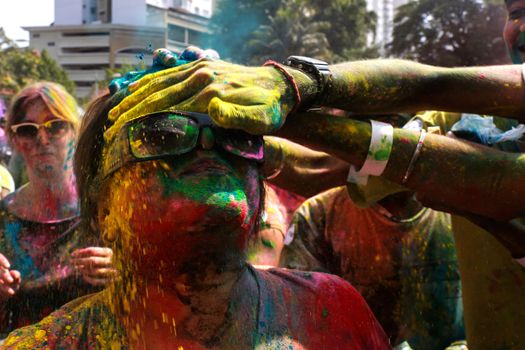 MALAYSIA, Kuala Lumpur: Revellers dance and spray colored powder during the Holi Festival in Kuala Lumpur on March 26, 2016. Holi, also called the Festival of Colours, is a popular Hindu spring festival observed in India, Malaysia and other countries at the end of the winter season on the last full moon day of the lunar month. 