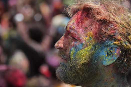 MALAYSIA, Kuala Lumpur: A man with his face colored by powder smiles as revellers dance and spray colored powder during the Holi Festival in Kuala Lumpur on March 26, 2016. Holi, also called the Festival of Colours, is a popular Hindu spring festival observed in India, Malaysia and other countries at the end of the winter season on the last full moon day of the lunar month. 