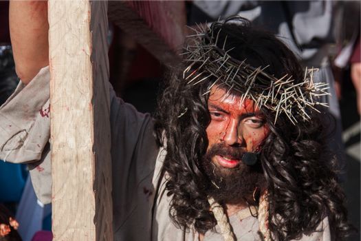 MEXICO, Mexico City: A man portraying Jesus carries a cross through the streets of Mexico City on March 25, 2016, as part of a Good Friday procession. The procession went through the Via Crucis, or stations of the cross, which tell of the crucifixion of Jesus.Good Friday is held on the Friday before Easter.