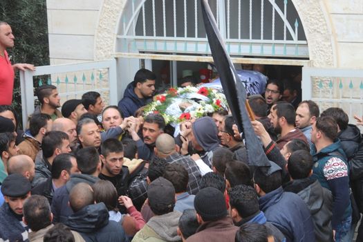 WEST BANK, Hebron: Relatives and Hebron residents mourn the body of Ramzi al-Qasrawi, 21, a Palestinian man shot dead by an Israeli soldier in a reported stabbing attack, during his funeral in the West Bank town of Hebron on March 26, 2016. Ramzi al-Qasrawi was killed on March 24, 2016 along with Abdul Fatah al-Sharif after they, the Israeli army said, wounded an Israeli soldier at the entrance to the heavily guarded Jewish settler enclave in the heart of the city.