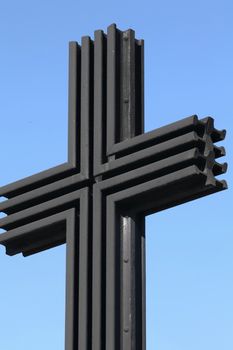 black iron cross on a background of blue sky