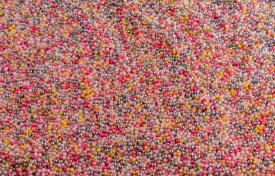 hundreds and thousands laid out on a tray to create a background.