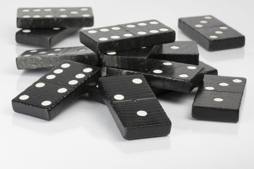 Composition of lying black domino bricks with white dots
