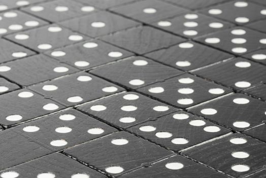 Composition of lying black domino bricks with white dots
