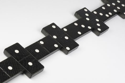 Composition of lying black domino bricks with white dots
