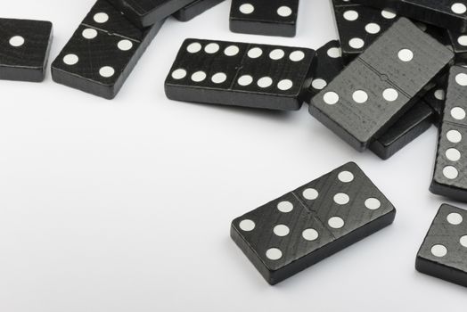 Composition of lying black domino bricks with white dots
