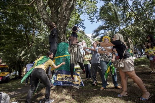 BRAZIL, Curitiba: Protesters beat effigies of President Dilma Rousseff and former President Lula in front of the Federal Court in Curitiba, Brazil on March 26, 2016. Traditionally on the Saturday before Easter, Catholics beat effigies of Judas the apostle. This year protesters in favor of impeachment of the President of Brazil, used the tradition as a political demonstration.