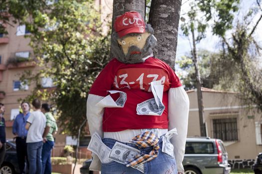 BRAZIL, Curitiba: A picture is taken of an effigie of Brazilian former president (2003-2011) Luiz Inacio Lula da Silva known as Lula as protesters beat effigies of President Dilma Rousseff and former President Lula in front of the Federal Court in Curitiba, Brazil on March 26, 2016. Traditionally on the Saturday before Easter, Catholics beat effigies of Judas the apostle. This year protesters in favor of impeachment of the President of Brazil, used the tradition as a political demonstration.