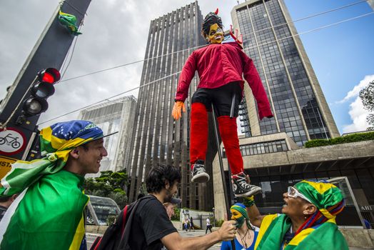 BRAZIL, Sao Paulo: Protesters raise an effigie of President Dilma Rousseff before burning it during a protest for the impeachment of President Dilma Rousseff, against former president Lula and against corruption in Petrobras scandal case in Sao Paulo, Brazil on March 26, 2016. Brazilian lawmakers relaunched impeachment proceedings against President Dilma Rousseff Thursday and a judge blocked her bid to bring her powerful predecessor into her cabinet, intensifying the political crisis engulfing her. 