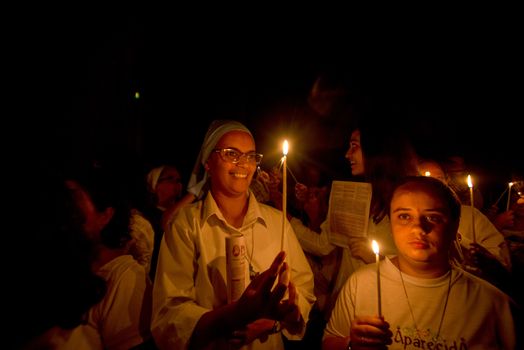 BRAZIL, Sao Paulo: Churchgoers hold candles as they attend Easter mass and vigil at São Paulo See Metropolitan Cathedral on March 26, 2016. Christians around the world are marking the Holy Week, commemorating the crucifixion of Jesus Christ, leading up to his resurrection on Easter.