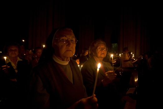 BRAZIL, Sao Paulo: Churchgoers hold candles as they attend Easter mass and vigil at São Paulo See Metropolitan Cathedral on March 26, 2016. Christians around the world are marking the Holy Week, commemorating the crucifixion of Jesus Christ, leading up to his resurrection on Easter.