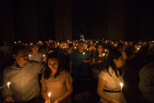 BRAZIL, Sao Paulo: Churchgoers hold candles as they attend Easter mass and vigil at São Paulo See Metropolitan Cathedral on March 26, 2016. Christians around the world are marking the Holy Week, commemorating the crucifixion of Jesus Christ, leading up to his resurrection on Easter.