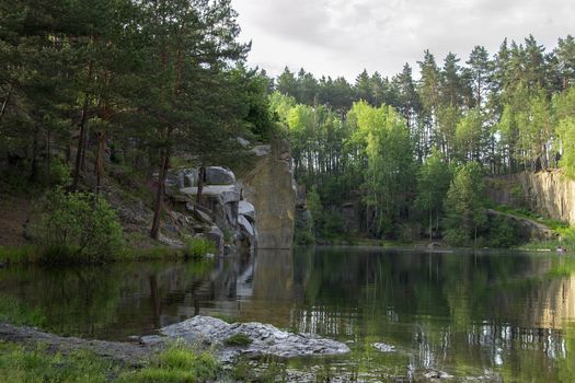 Lake in the stone canyon surrounded by forest