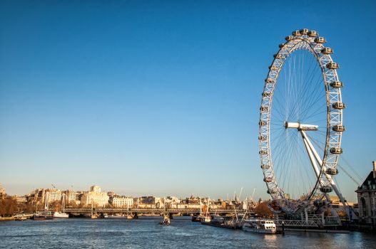 London Eye (135 m tall, diameter of 120 m) - a famous tourist attraction over river Thames