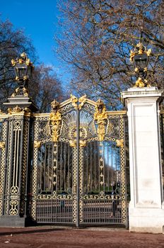 Gate with gilded ornaments in Buckingham Palace. Buckingham Palace is a symbol and home of the British monarchy.