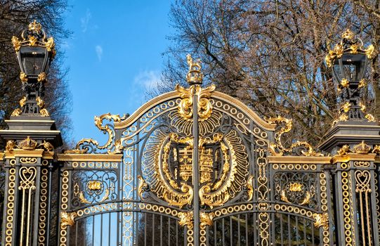 Gate with gilded ornaments in Buckingham Palace. Buckingham Palace is a symbol and home of the British monarchy.