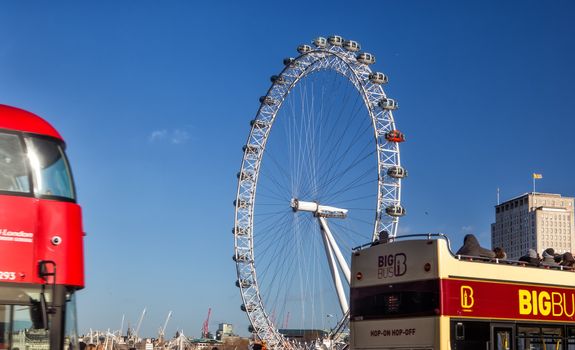 London Eye (135 m tall, diameter of 120 m), a famous tourist attraction over river Thames.
