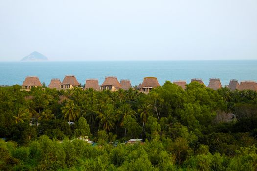 Beautiful seaside resort with group of beach bungalow, tourist area among coconut tree, sea and mountain, eco green environment, great place for holiday vacation in summer at Nha Trang, Vietnam