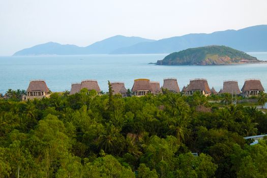 Beautiful seaside resort with group of beach bungalow, tourist area among coconut tree, sea and mountain, eco green environment, great place for holiday vacation in summer at Nha Trang, Vietnam