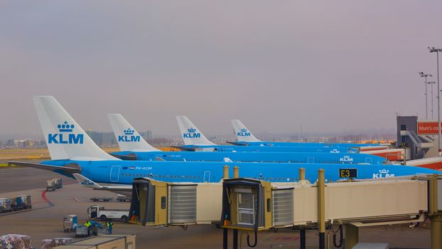 Amsterdam, Netherlands - March 11, 2016: KLM plane being loaded at Schiphol Airport