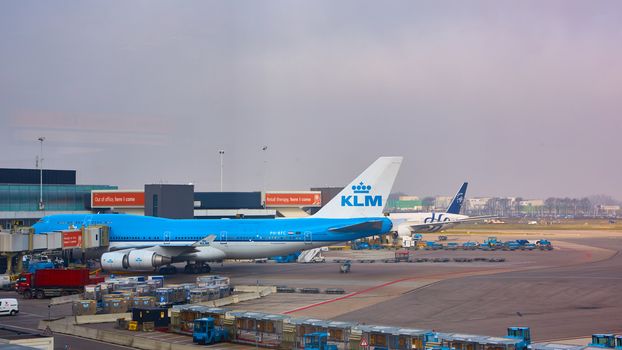 Amsterdam, Netherlands - March 11, 2016: KLM plane being loaded at Schiphol Airport