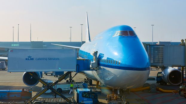 Amsterdam, Netherlands - March 11, 2016: KLM plane being loaded at Schiphol Airport