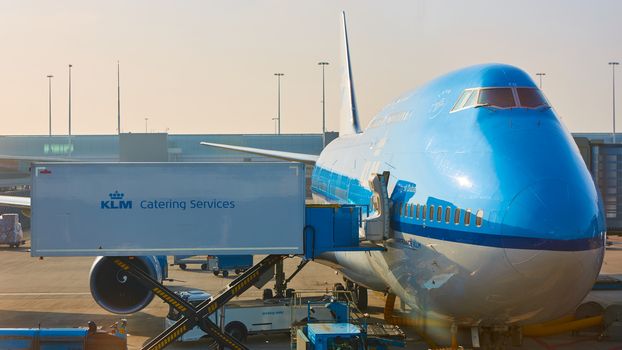 Amsterdam, Netherlands - March 11, 2016: KLM plane being loaded at Schiphol Airport