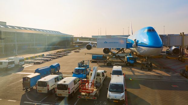 Amsterdam, Netherlands - March 11, 2016: KLM plane being loaded at Schiphol Airport