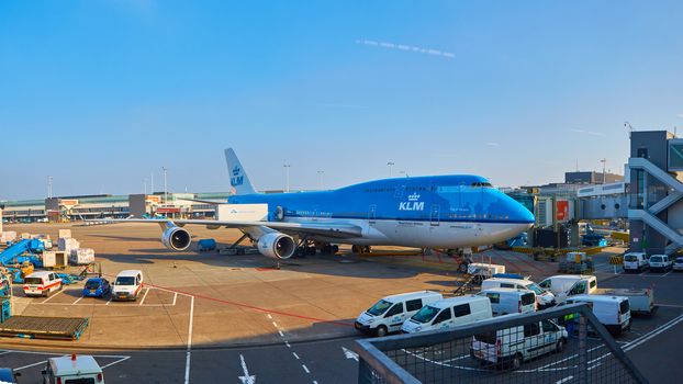 Amsterdam, Netherlands - March 11, 2016: KLM plane being loaded at Schiphol Airport