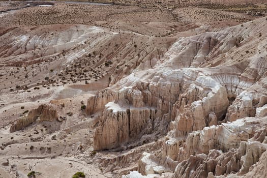 Eroded rock formations at the head of a river valley feeding the River Lauca high up on the Altiplano of northern Chile in Lauca National Park.