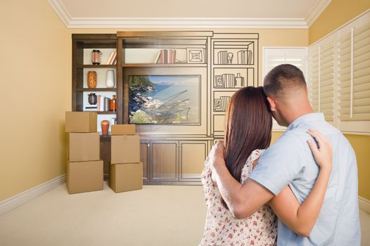 Young Military Couple Looking At Drawing of Entertainment Unit In Room With Moving Boxes.