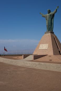 Statue of Christ on the top of the Morro de Arica, a cliff that towers above the port city of Arica in Chile.