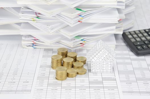 House and step pile of gold coins on finance account have calculator and overload of paperwork with colorful paperclip as background.