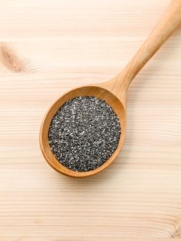 Nutritious chia seeds in wooden spoon for diet food ingredients.