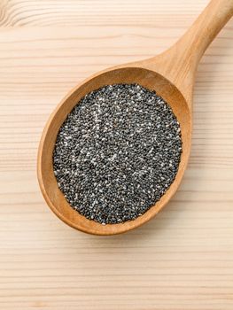 Nutritious chia seeds in wooden spoon for diet food ingredients.