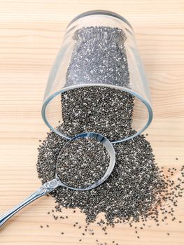 Nutritious chia seeds in glass bowl with metal spoon for diet food ingredients.
