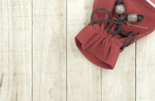 Small red bag on wood pattern background, retro style photo.