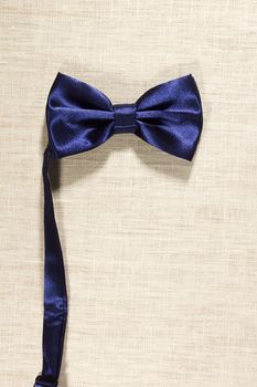 Bow tie on a background of white linen napkins