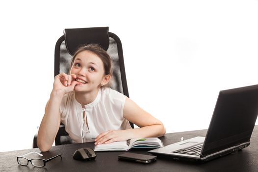 the business woman sits at office table with the laptop