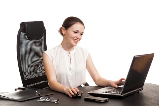 the business woman sits at office table with the laptop