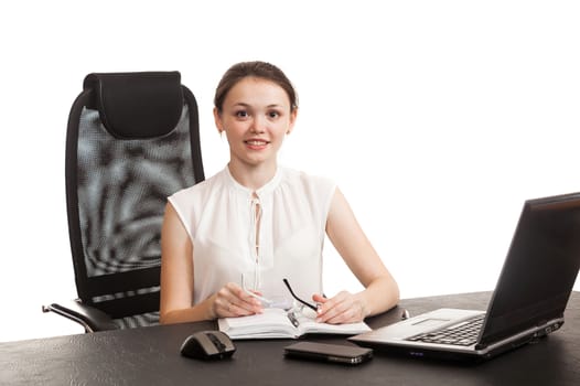 the business woman sits at office table with the laptop