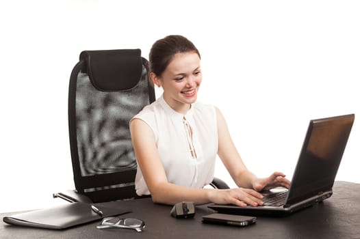 the business woman sits at office table with the laptop